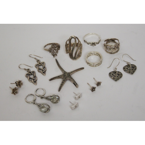 622 - A collection of silver earrings, marcasite starfish pendant and five ladies silver dress rings.