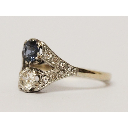 628 - An Art Deco two stone sapphire and diamond ring, in openwork diamond set mount, unmarked white preci... 