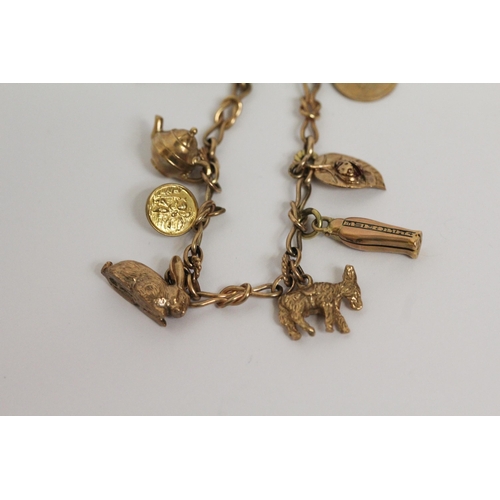 643 - A 9ct gold charm bracelet, set with animal and other 9ct gold charms. gross weight 21.6 g, 19 cms lo... 