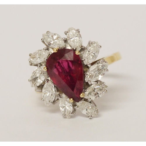 655 - A ruby and diamond cluster ring, The claw set pear shaped ruby surrounded by marquise shaped diamond... 