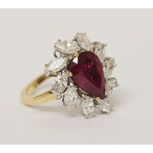 655 - A ruby and diamond cluster ring, The claw set pear shaped ruby surrounded by marquise shaped diamond... 