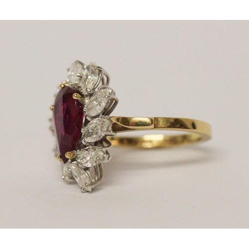 655 - A ruby and diamond cluster ring, The claw set pear shaped ruby surrounded by marquise shaped diamond... 