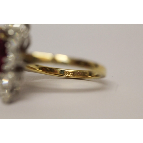 655 - A ruby and diamond cluster ring, The claw set pear shaped ruby surrounded by marquise shaped diamond... 