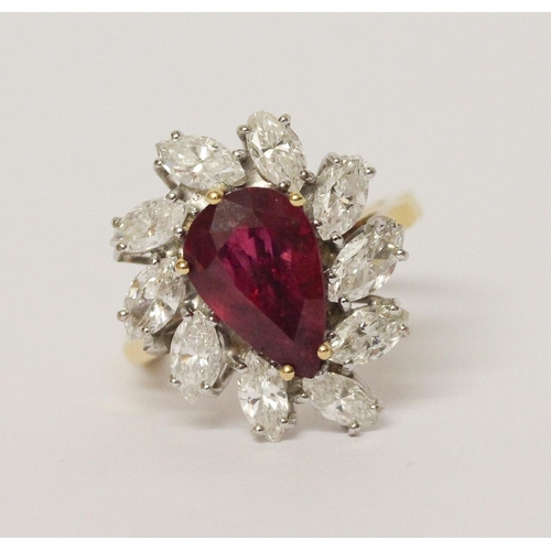 655 - A ruby and diamond cluster ring, The claw set pear shaped ruby surrounded by marquise shaped diamond... 