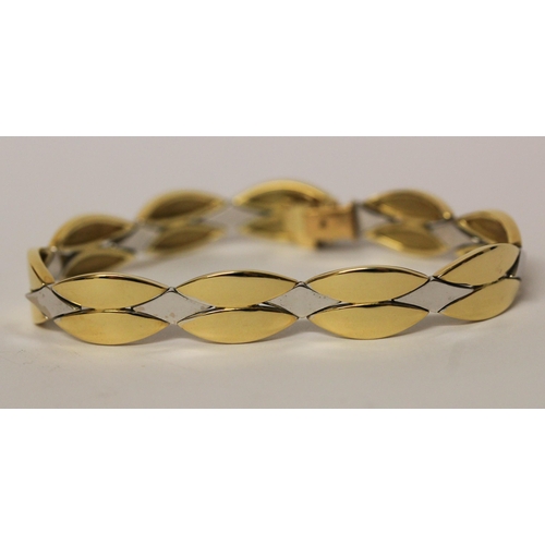 657 - A modern 18ct bi-colour gold bracelet, by Michael Platt, of smooth polished leaf style plaited desig... 