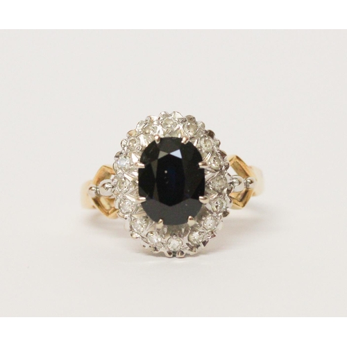 658 - A sapphire and diamond oval cluster ring, shank of  18ct gold. Ring size M 1/2. Gross weight 6.3g