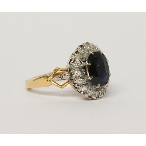 658 - A sapphire and diamond oval cluster ring, shank of  18ct gold. Ring size M 1/2. Gross weight 6.3g