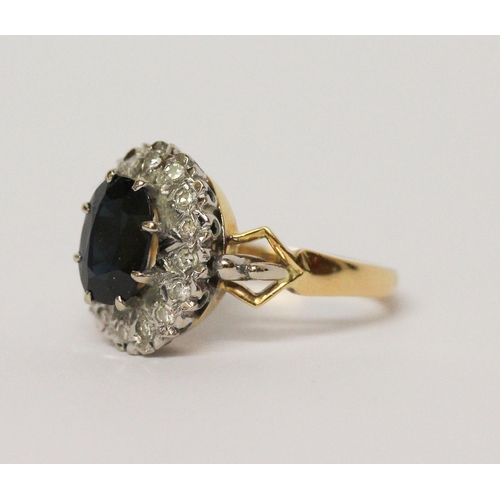 658 - A sapphire and diamond oval cluster ring, shank of  18ct gold. Ring size M 1/2. Gross weight 6.3g