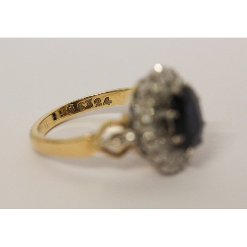 658 - A sapphire and diamond oval cluster ring, shank of  18ct gold. Ring size M 1/2. Gross weight 6.3g