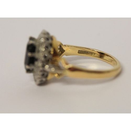 658 - A sapphire and diamond oval cluster ring, shank of  18ct gold. Ring size M 1/2. Gross weight 6.3g