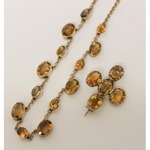 662 - A vintage citrine riviere choker necklace in white metal, 36 cms long, and five stone citrine brooch... 