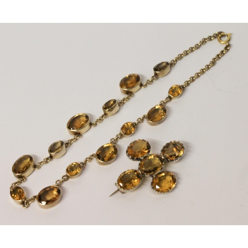 662 - A vintage citrine riviere choker necklace in white metal, 36 cms long, and five stone citrine brooch... 