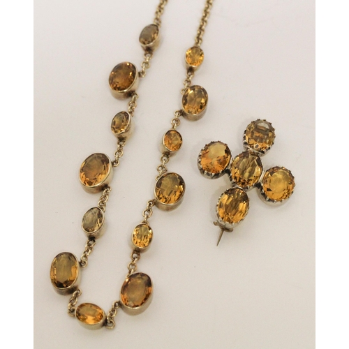 662 - A vintage citrine riviere choker necklace in white metal, 36 cms long, and five stone citrine brooch... 