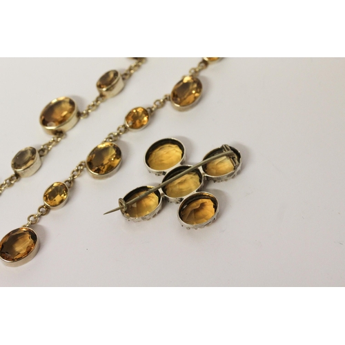 662 - A vintage citrine riviere choker necklace in white metal, 36 cms long, and five stone citrine brooch... 