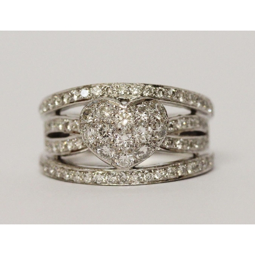 666 - A modern diamond wide band ring, the centre with pave diamond heart within bands of brilliant cut di... 