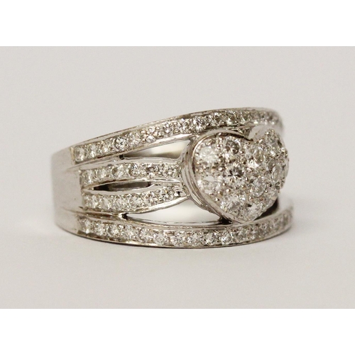 666 - A modern diamond wide band ring, the centre with pave diamond heart within bands of brilliant cut di... 