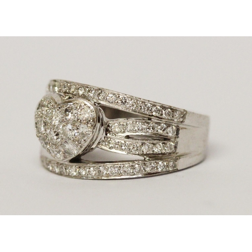 666 - A modern diamond wide band ring, the centre with pave diamond heart within bands of brilliant cut di... 