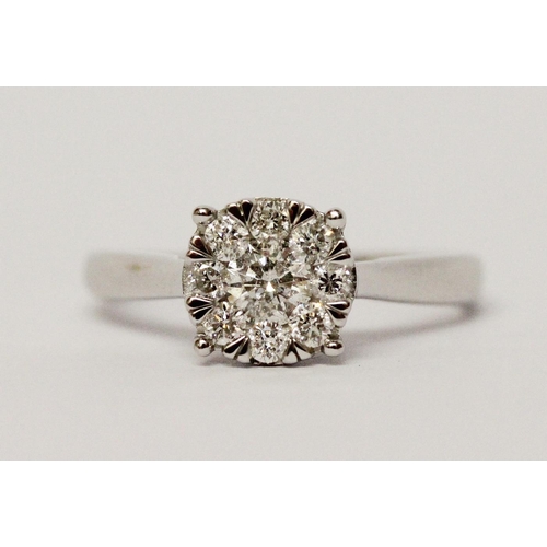 668 - A modern diamond cluster ring, half a carat diamond weight on 9ct white gold band. Ring size M, weig... 