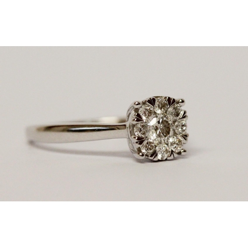 668 - A modern diamond cluster ring, half a carat diamond weight on 9ct white gold band. Ring size M, weig... 