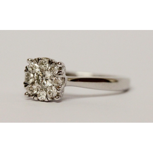 668 - A modern diamond cluster ring, half a carat diamond weight on 9ct white gold band. Ring size M, weig... 