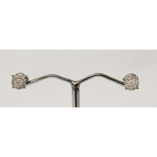 670 - A pair of modern diamond ear studs, with safety screw posts, 9ct white gold.