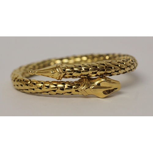 674 - A snake bangle, of sprung design in 18ct yellow gold, marked 750. Total weight 35.4 grams