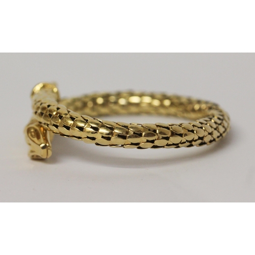 674 - A snake bangle, of sprung design in 18ct yellow gold, marked 750. Total weight 35.4 grams