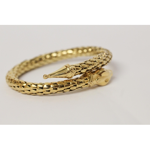 674 - A snake bangle, of sprung design in 18ct yellow gold, marked 750. Total weight 35.4 grams