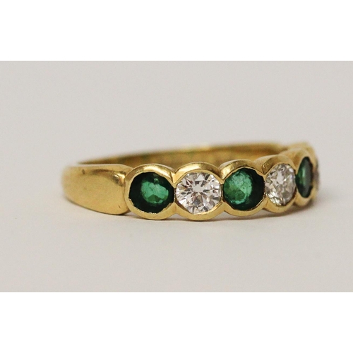 684 - An emerald and diamond half hoop ring, set circular brilliant cut diamonds alternating with emeralds... 