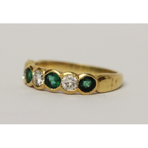 684 - An emerald and diamond half hoop ring, set circular brilliant cut diamonds alternating with emeralds... 