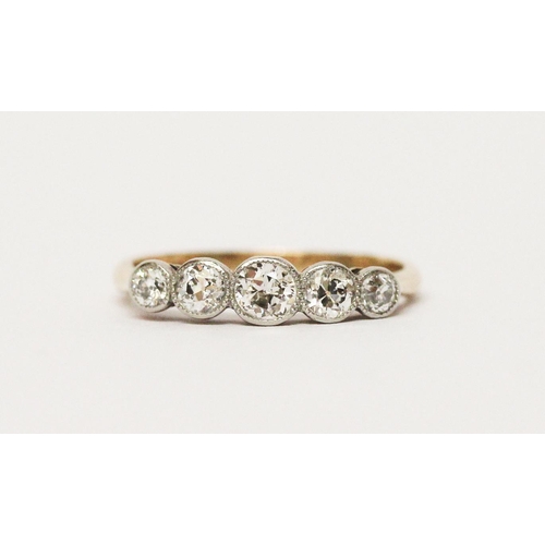 686 - An Edwardian five stone diamond ring, the graduated brilliant cut diamonds in millegrain settings, o... 