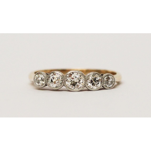 686 - An Edwardian five stone diamond ring, the graduated brilliant cut diamonds in millegrain settings, o... 