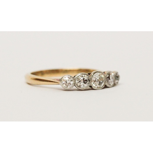 686 - An Edwardian five stone diamond ring, the graduated brilliant cut diamonds in millegrain settings, o... 