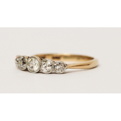 686 - An Edwardian five stone diamond ring, the graduated brilliant cut diamonds in millegrain settings, o... 