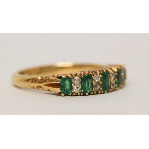 715 - 18ct emerald and diamond half hoop ring, in carved setting, hallmarked. Ring size N Weight 4.6 g