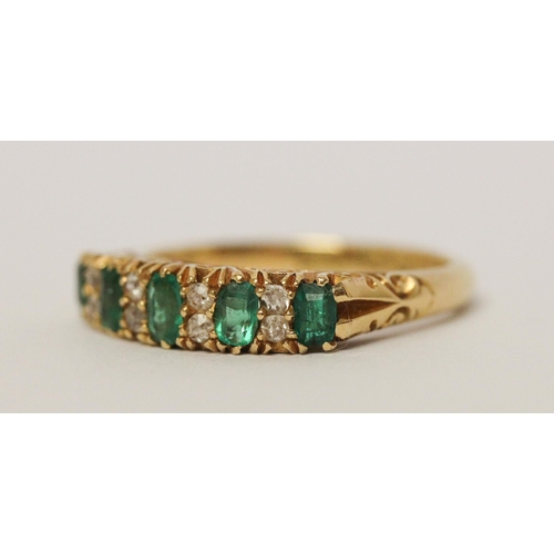 715 - 18ct emerald and diamond half hoop ring, in carved setting, hallmarked. Ring size N Weight 4.6 g