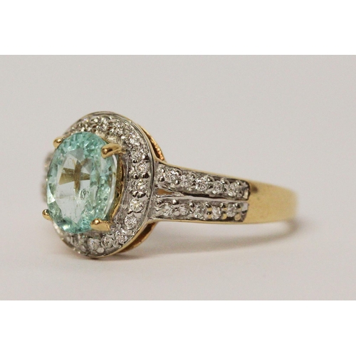 722 - An aquamarine and diamond oval cluster ring, with diamond shoulders, hallmarked 18ct yellow gold, ri... 