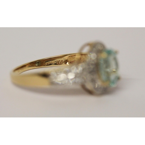 722 - An aquamarine and diamond oval cluster ring, with diamond shoulders, hallmarked 18ct yellow gold, ri... 