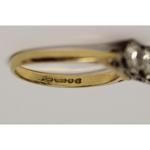 724 - A three stone diamond ring, in claw setting on 18ct hallmarked yellow gold band, total diamond weigh... 