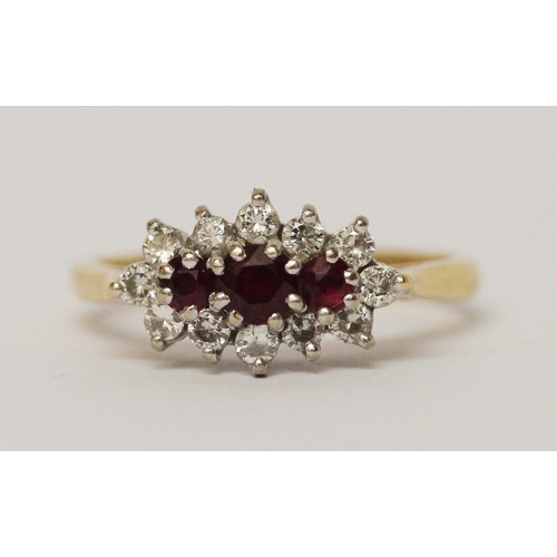 728 - A three stone ruby and diamond cluster ring, on 18ct yellow gold band. Ring size N, weight 3.5g