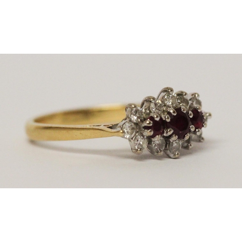 728 - A three stone ruby and diamond cluster ring, on 18ct yellow gold band. Ring size N, weight 3.5g