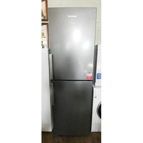 854 - A Blomberg 6' tall half and half fridge freezer in silver case