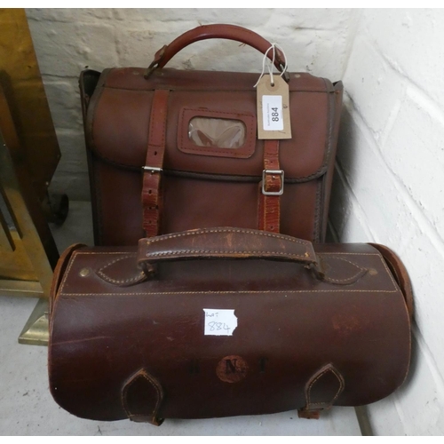 884 - A brown leather carrying case with a set of four balls in and brown leather case with two bowling ba... 