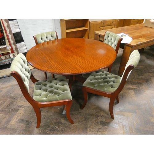 250 - A circular mahogany single pillar dining table with fold away centre leaf and four matching Regency ... 