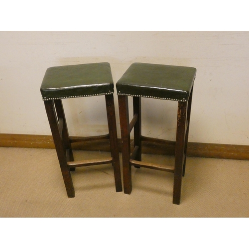 394 - Pair of oak bars stools with green antique leather studded tops