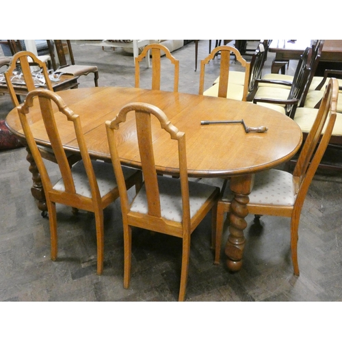 411 - Early 20th century light oak oval extending dining table, with centre leaf and handle on barley twis... 