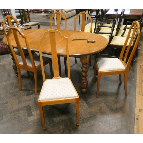 411 - Early 20th century light oak oval extending dining table, with centre leaf and handle on barley twis... 