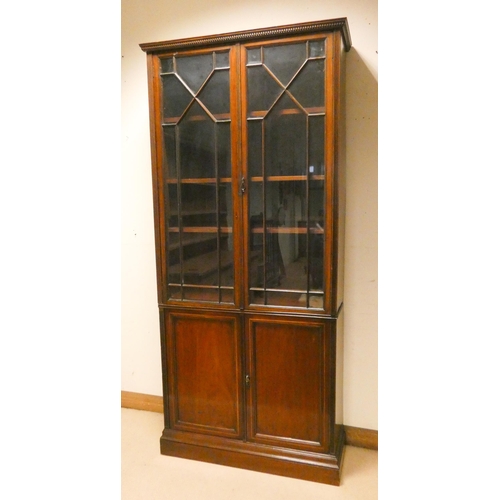 422 - Georgian mahogany line inlaid two door bookcase with lattice glazing, cupboards under, 40