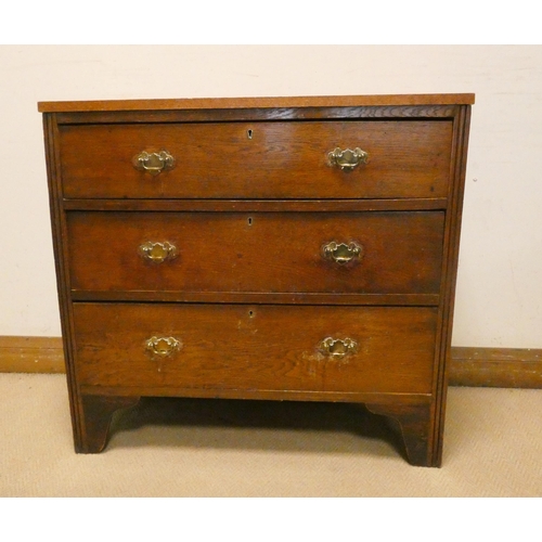 430 - Oak chest of three long drawers with brass handles on bracket feet, 34