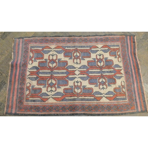 176 - Two small red and patterned wool pile rugs